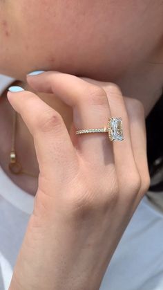 a close up of a person wearing a diamond ring