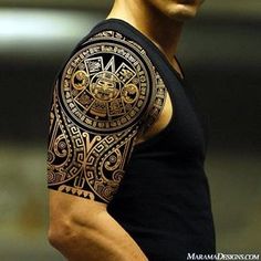 a black and white photo of a man's arm with an intricate tattoo design on it