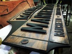 a wooden sign that is sitting on top of a table