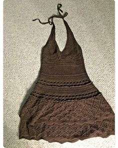 a crocheted halter top hanging on a wall