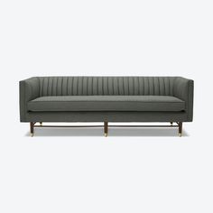 a gray couch sitting on top of a wooden frame