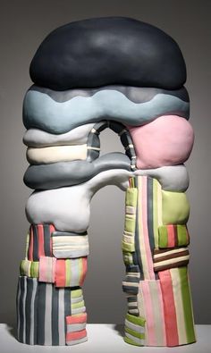 a stack of folded towels sitting on top of each other in front of a gray background