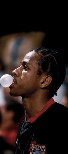 a young man blowing bubbles into his mouth
