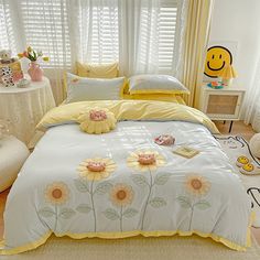 a bed with sunflowers and smiley faces on it