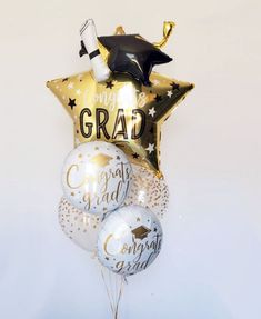 graduation balloons and confetti in the shape of a star with congratulations written on them