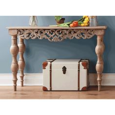 a white suitcase sitting under a wooden table