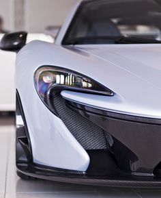 the front end of a white sports car