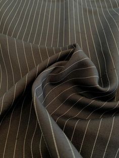 a close up view of a brown and white pinstripe suit fabric with vertical stripes