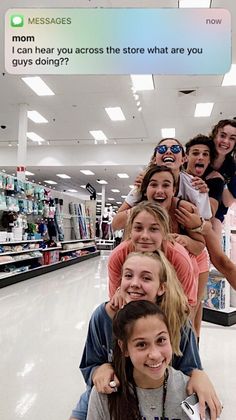 a group of young women standing next to each other in a store