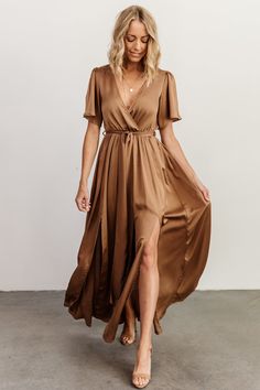 a woman in a brown dress is walking