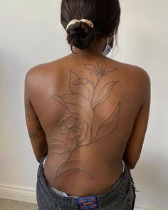 the back of a woman with tattoos on her body