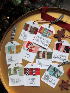 some christmas tags are hanging on a table