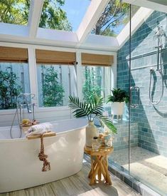 a bath room with a stand up shower and a large tub in the middle of it