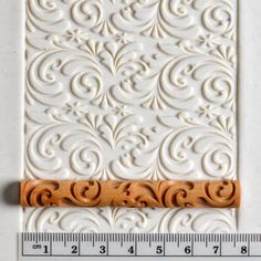 a ruler is next to a decorative wall panel