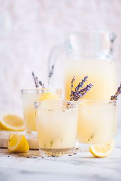 three glasses filled with lemonade and lavender