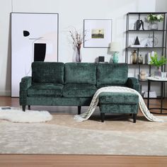 a living room with a green couch and white rug