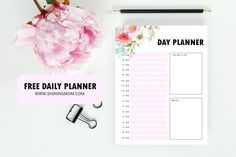 the free daily planner is on top of a desk next to pink flowers and a pen