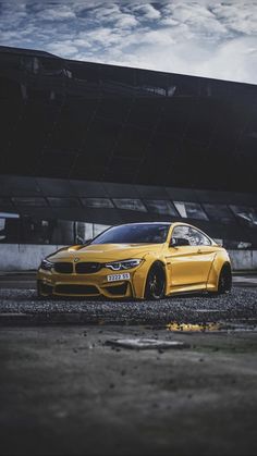 a yellow car parked in front of a building