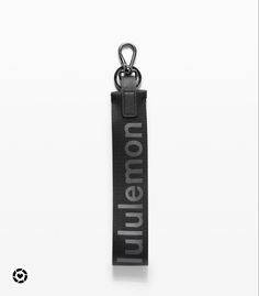 a key chain with the word union printed on it, hanging from a metal hook