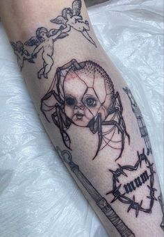 a tattoo on the leg of a person with barbed wire around it and an image of a woman's face