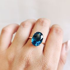 This stunning ring is set in 14k Solid Yellow Gold with Natural London Blue Topaz having utmost precision. It is an unique statement gemstone ring for nearly every occasion and is completely hassle-free jewelry. ITEM DETAILS: * Gem: London Blue topaz * Gem Size: 10X14mm * Gem Shape: Oval Cut * Gem Weight: 7.65 carats * Gold Purity: 14KT  * Gold Weight: 1.76 gram * Total Weight of the Ring: 3.29 gram The Gold purity is guaranteed and it comes with authentic 14KT gold hallmark. Since my items are handmade, they are absolutely nickel and lead free. CUSTOMIZATION: * Size Customization is available for this ring and it is available in all ring sizes. Kindly choose your ideal ring size from the drop-down. * Gemstone customization is available and the it can be substituted with a gem of your choi November Birthstone Ring, Handmade Jewelry Box, London Blue Topaz Ring, November Birthstone, Ring Oval, Yellow Gold Ring, London Blue Topaz, Multi Stone Ring, Blue Topaz Ring