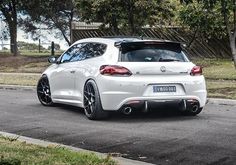 the rear end of a white sports car