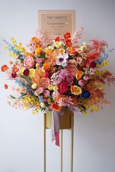 a bunch of flowers that are sitting on a stand