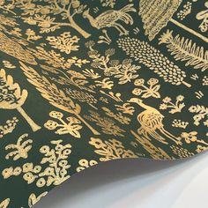 a black and gold wallpaper with trees, flowers, birds and other things on it