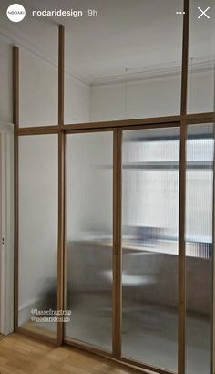 an empty room with sliding glass doors and wood flooring on the side of it