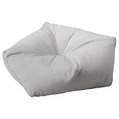 a white pillow sitting on top of a floor