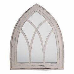 an arched window with white paint on the front and side panels, made out of wood