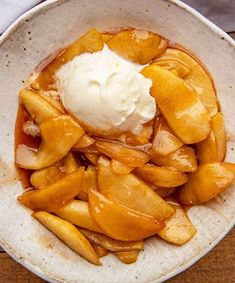 a white bowl filled with sliced apples and ice cream