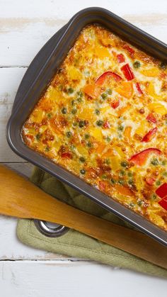 a casserole dish with tomatoes, peppers and cheese