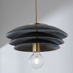 a black and gold pendant light hanging from a ceiling