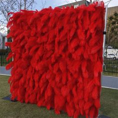 a large red piece of art made out of feathers