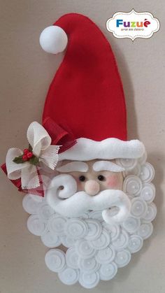 a santa clause hat and beard made out of plastic buttons on a white background with red ribbon