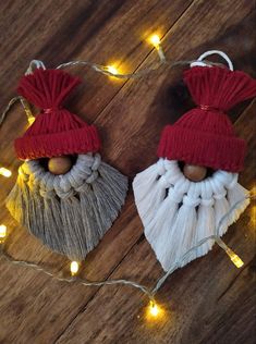 two christmas ornaments with lights strung around them