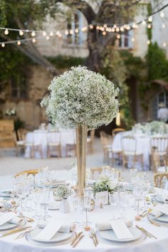 a table is set with white linens and place settings