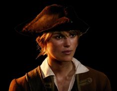 a woman wearing a pirate hat in the dark