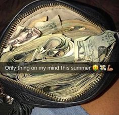 a purse filled with lots of money sitting on top of a table