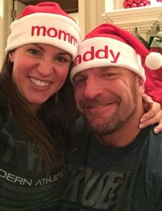 a man and woman wearing christmas hats with the word mommy baby on it's forehead