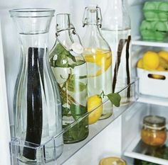 an open refrigerator filled with lots of different types of drinks and condiments in glass containers