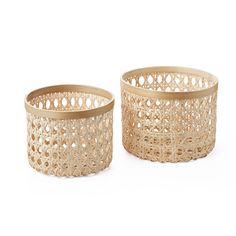 two wooden baskets sitting next to each other on a white surface and one is empty