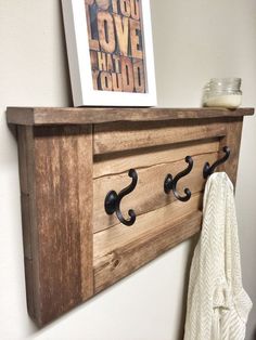 the coat rack is made from an old door and has hooks for coats on it