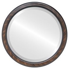 a round mirror with a wooden frame and metal trim around the edges, on a white background