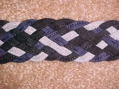 a close up of a black and white braid on carpeted area with brown flooring