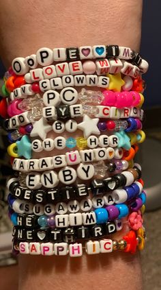a stack of bracelets with words written on them