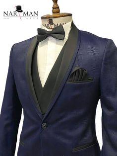 a mannequin wearing a tuxedo with a bow tie on it's lapel