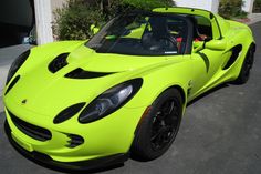 a lime green sports car parked in front of a house
