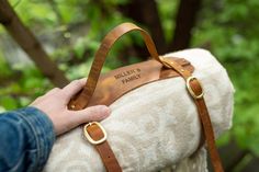 a person holding onto a white and brown bag in their left hand, with the words miller's family on it